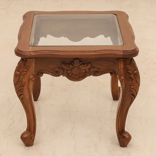 Antique glass side table with carved teakwood base and cabriole legs