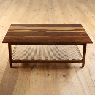 Teakwood coffee table with woven cane shelf and tapered legs