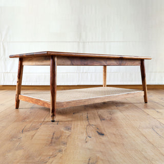 Teakwood coffee table with woven cane shelf and tapered legs