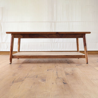 Teakwood coffee table with woven cane shelf and tapered legs
