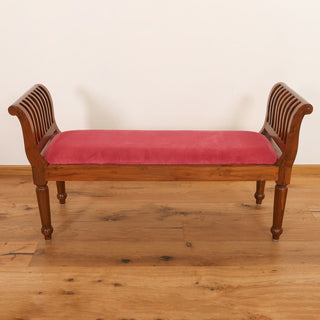 Red velvet rolled-arm bench with slatted teakwood arms and turned legs
