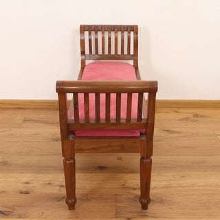 Red velvet rolled-arm bench with slatted teakwood arms and turned legs