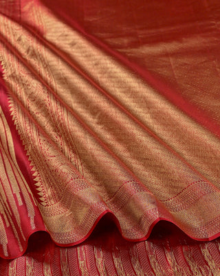 Crimson red Kanjivaram silk saree with gold zari stripes and brocade pallu
