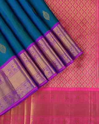 Teal green and blue dual-tone Kanjivaram saree with purple peacock border