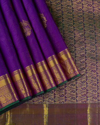 Purple Kanjivaram silk saree with gold zari stripes and green brocade pallu