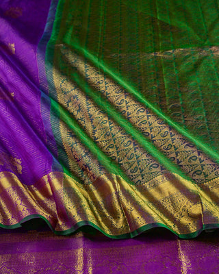 Purple Kanjivaram silk saree with gold zari stripes and green brocade pallu