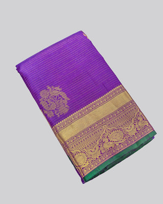 Purple Kanjivaram silk saree with gold zari stripes and green brocade pallu
