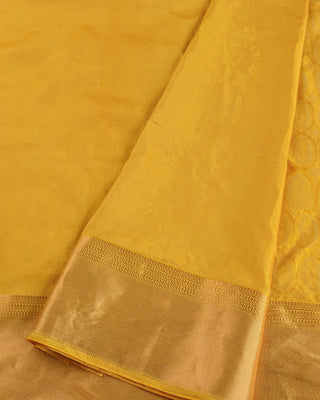 Golden yellow soft silk saree with gold zari oval motifs and peacock pallu design