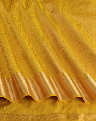 Golden yellow soft silk saree with gold zari oval motifs and peacock pallu design