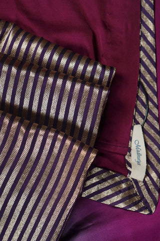 Emerald green to magenta purple ombre modal silk saree with zari striped facing and navy blouse