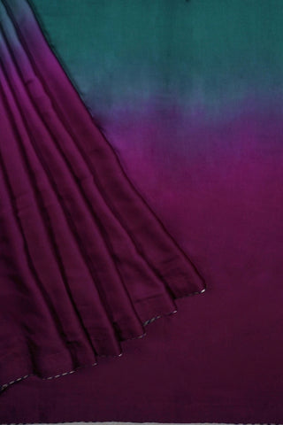 Emerald green to magenta purple ombre modal silk saree with zari striped facing and navy blouse