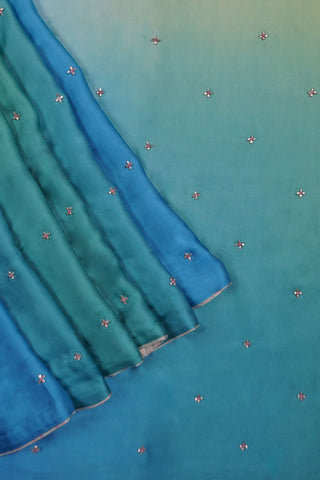 Light green to teal ombre modal silk saree with hand embroidered floral buttis and woven blouse